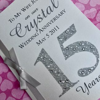 Luxury hand crafted crystal wedding anniversary card with ribbons and diamante accents. Personalised with name and date.